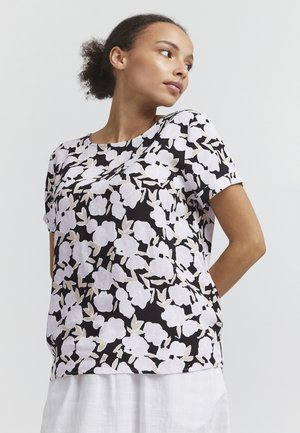 Short-sleeve top with a black base featuring a floral pattern in white and light beige. Rounded neckline, relaxed fit, and soft fabric texture.