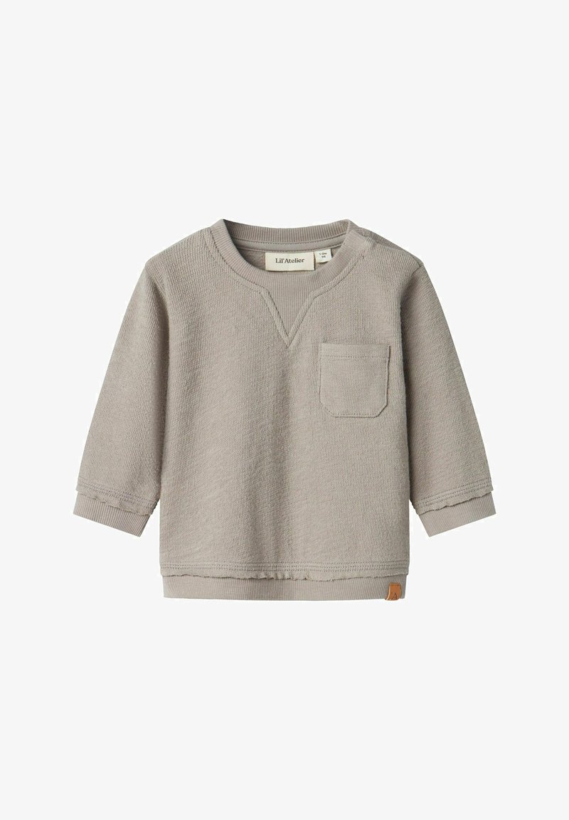 Maglietta a maniche lunghe grigia chiara con scollo a V, dotata di tasca frontale e polsini a costine. Il tessuto ha una finitura strutturata.