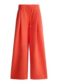 Pantalon à jambes larges orange avec ceinture élastique et cordon de serrage, confectionné en tissu lisse, conçu pour une coupe ample et confortable.