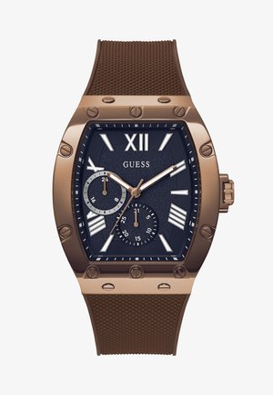 Brun silikonerem ur med en mørkeblå tekstureret skive, romerske tal markeringer og to sub-dials med sølv detaljer og skruer.