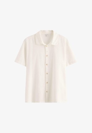 Camicia in lino bianco a maniche corte con colletto classico e sei bottoni frontali, mostrata su sfondo bianco.