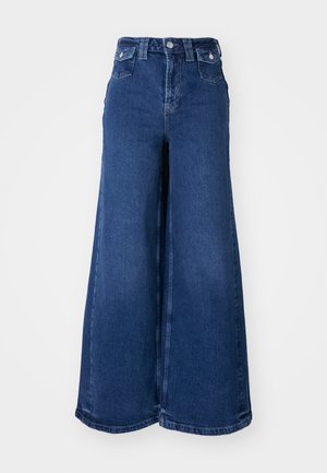 Wijd-uitlopende jeans in donkerblauwe denim, met een hoge taille, sluiting met een knop aan de voorkant en twee voorzakken. Zachte textuur met minimale stiksels.