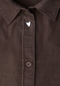 Brown corduroy shirt with a pointed collar, silver heart-shaped button accent, and a round brown button with "STREET ONE" text.