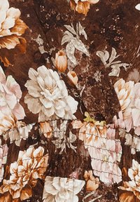 Brun tyg med stora vita, orange och rosa blommönster samt rynkad, elastisk sömdetalj.
