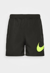 Svart träningsshorts med elastisk midja och neongrönt Nike swoosh-logotyp på nederkant av vänster ben.