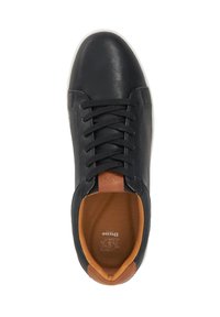 Black leather sneaker with perforated side panels, flat laces, and a brown heel accent. White rubber sole and textured inner lining.