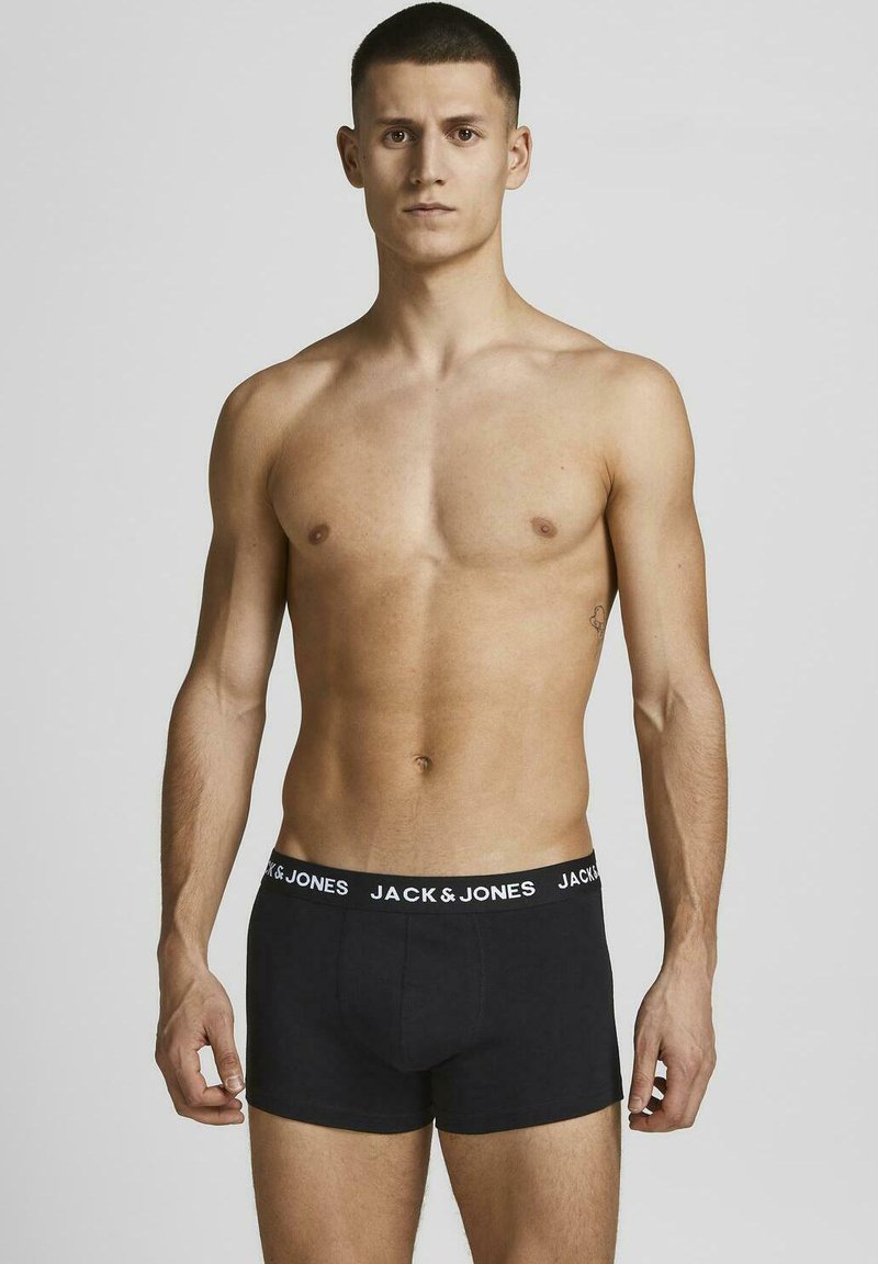 Mustat puuvillabokserit, joissa on valkoinen joustovyö, jossa on "JACK & JONES" -logo. Minimalistinen muotoilu, tiukka malli, sileä pinta.