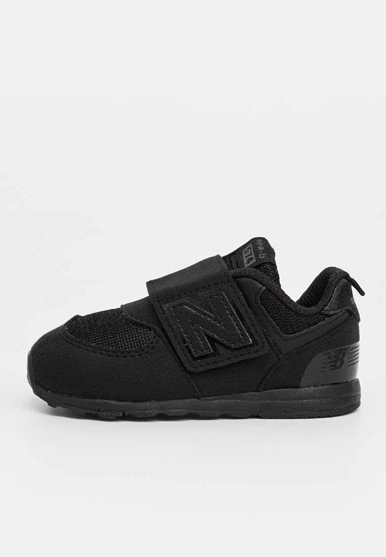Baskets de sport noires avec une partie supérieure en mesh respirant, fermeture à sangle Velcro et semelle rembourrée. Semelle en caoutchouc pour traction et durabilité.
