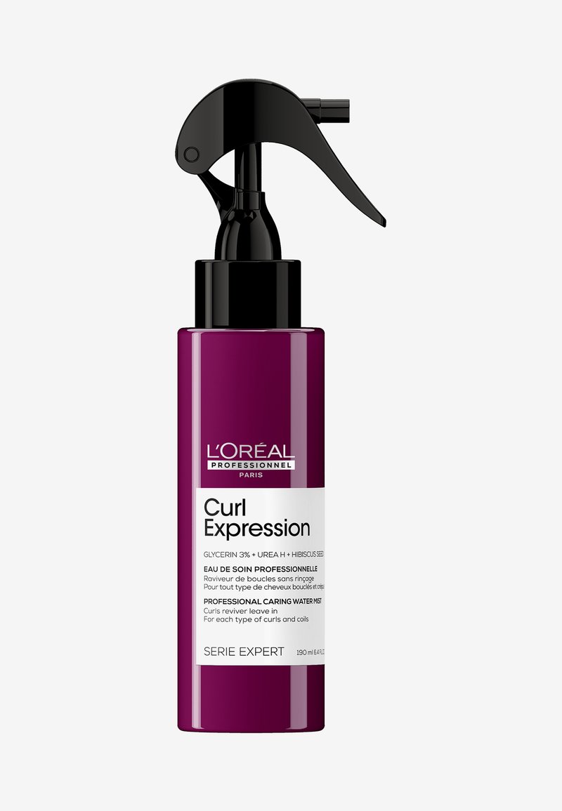 Curlspray met watermist in een paarse fles met een zwarte spraymond. Bevat glycerine, urine en hibiscus om de definitie van krullen te verbeteren.