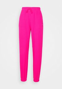 Pink ribbed sweatpants with an elastic waistband, drawstring, and tapered ankles. Features a subtle logo detail at the hip.