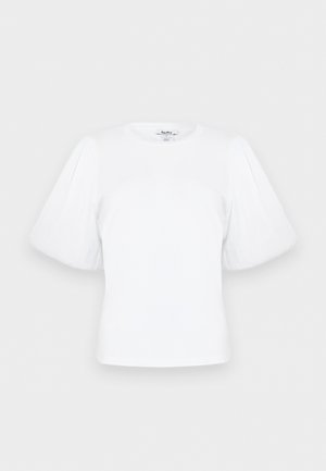 Blouse blanche à manches courtes bouffantes avec un col rond, présentée à plat sur un fond clair.