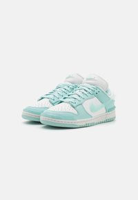 Mint green and white Nike sneakers with perforated toe, padded tongue, flat laces, rubber sole, and signature swoosh logo on the side.