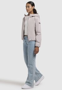 Light pink, hooded jacket with a zipper and elastic cuffs, paired with light blue flared jeans and white sneakers. Simple, clean design.