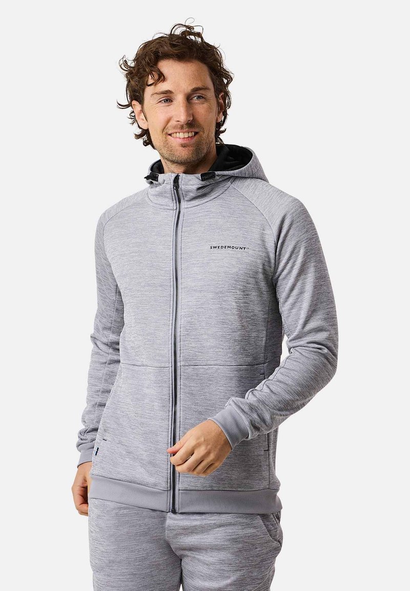 Graue Zip-Hoodie mit strukturiertem Muster, schwarzem Futter der Kapuze und Taschen. Hat eine enge Passform mit Bündchen und geripptem Saum für zusätzlichen Komfort.