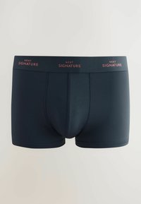 Tumed sinised bokserid siledast kangast, mis on mugavalt istuvad ja millel on elastne vöö, millel on punastes tähtedes tekst "NEXT SIGNATURE".