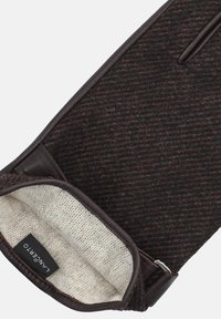 Brązowe rękawice z mieszanki wełny z akcentami skórzanymi. Wnętrze ma miękką, teksturowaną kremową podszewkę. Zawiera regulowany pasek i metkę.