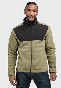 Fleecejacke in Olivgrün und Schwarz, mit hohem Kragen, Reißverschluss und schwarzen Akzentpanelen an den Schultern und der Brust.