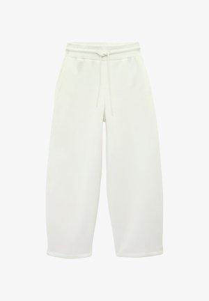 Jogging large couleur blanc cassé avec taille élastique et cordon, featuring poches latérales et coupe décontractée.