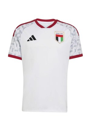 White soccer jersey with red accents, short sleeves, V-neck design, patterned shoulders, and UAE FA crest on the left chest. Adidas logo on the right.