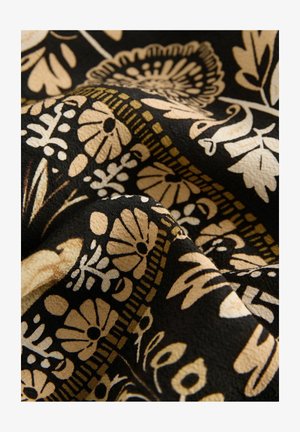 Tissu à motifs floraux noir avec des accents beiges, arborant des fleurs, des feuilles et des designs géométriques complexes, avec une surface douce et texturée.