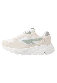 Beige and white sneakers with mesh and suede upper, green accents, perforated detailing, and a textured white rubber sole.