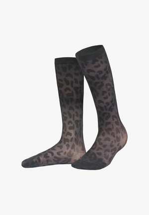 Chaussettes noires transparentes avec un motif léopard, d'une texture lisse et d'une bande noire unie en haut, s'étendant jusqu'au milieu du mollet.