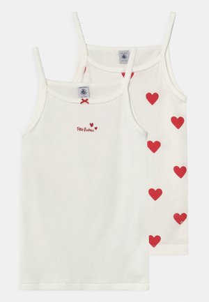 Two white cotton tank tops with thin straps; one features red hearts pattern, the other has a small red logo and heart design.