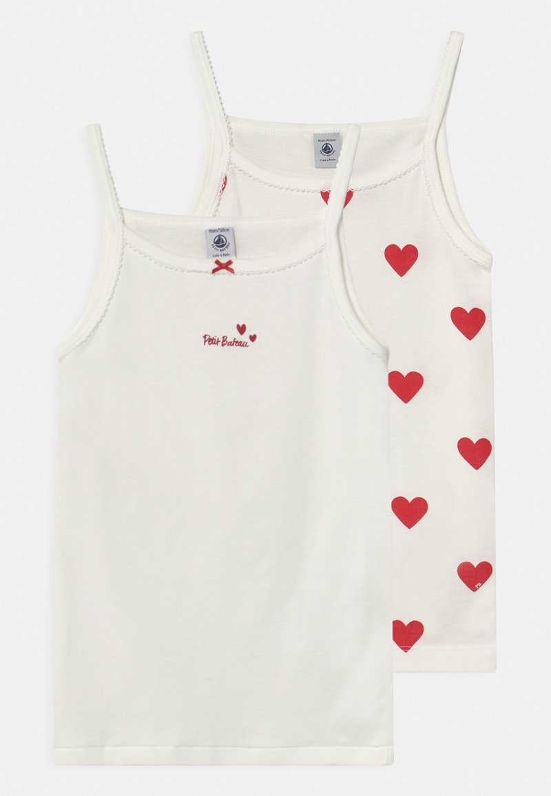 Two white cotton tank tops with thin straps; one features red hearts pattern, the other has a small red logo and heart design.