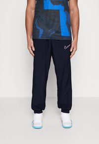 Nike Performance NIKE ACADEMY23 TRACK PANTS - Træningsbukser - obsidian/obsidian/white