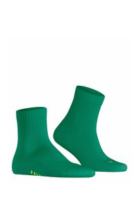 Calzini alla caviglia in cotone verde con polsini a costine e texture liscia. Presentano un dettaglio del logo giallo sul lato. Design corto e aderente.