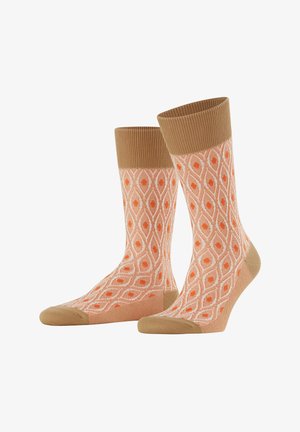 Orange Socken mit Muster im Diamantdesign, einem gerippten, sandfarbenen Bündchen und einer einfarbigen sandfarbenen Spitze und Ferse. Hergestellt aus einem weichen, flexiblen Material.