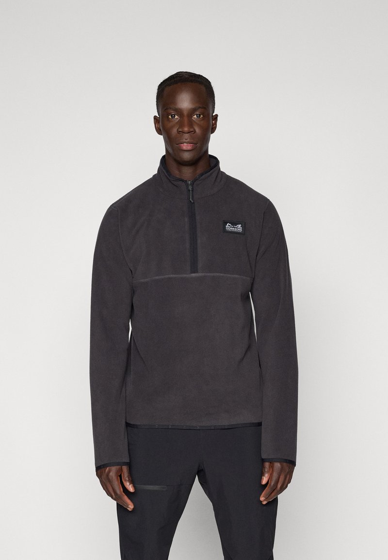 Grå fleece-pullover med kvart-zip hals, lange ærmer og et lille brystlogo. Blød tekstur, afslappet pasform, enkelt design.