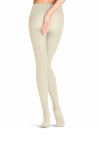 Collants beiges en matériau texturé avec un design sans couture. Présentent une fine ligne rose courant verticalement le long du dos.