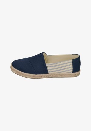 Navy canvas slip-on shoe with espadrille-style jute sole, featuring striped fabric accents and a rounded toe design.