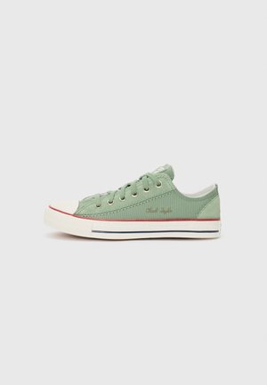 Green canvas low-top sneakers with white rubber toe cap, featuring red and navy stripes on the sole and silver eyelets for laces.