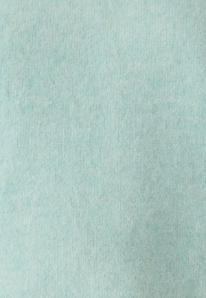 Tissu tricoté bleu clair avec une texture douce et duveteuse et un motif de tricot visible partout.