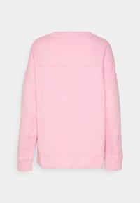 Pink sweatshirt featuring a relaxed fit, crew neckline, and ribbed cuffs. Smooth texture with minimal stitching details on the back.