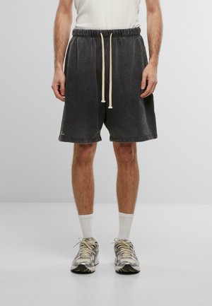 Dark gray cotton shorts with a relaxed fit, featuring an elastic waistband and drawstring. Accented with off-white threading and visible stitches.