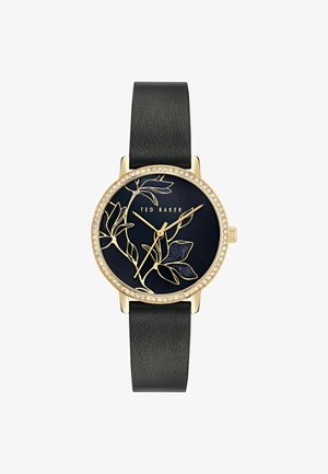Zwarte leren bandhorloge met vergulde kast, kristallen rand, marineblauwe wijzerplaat met gouden bloemenpatroon en logo "TED BAKER."