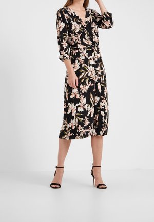 Zwarte bloemenjurk met een diepe V-hals, driekwartmouwen en een getailleerde taille. Accentuering met roze en witte bloemmotieven.