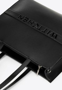Borsa a tote in pelle nera con manici doppi, chiusura a zip superiore e nome del marchio in rilievo "WITTCHEN" sul pannello frontale.