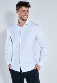 Hellblau und weiß gestreiftes Langarmhemd mit Kragen, Knopfleiste und abgerundetem Saum. Hergestellt aus einem glatten Stoff.