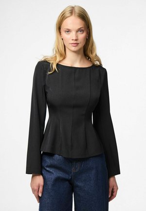 Black peplum top with a round neckline, long sleeves, and vertical seams, paired with blue wide-leg jeans, set against a neutral background.