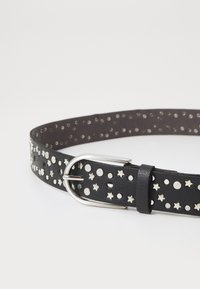 Black leather belt featuring decorative silver studs in circular and star shapes, with a silver metal buckle and a smooth texture.