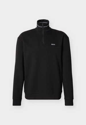 Schwarzer Pullover mit langen Ärmeln, Reißverschluss bis zum Viertel, hohem Kragen mit weißer Paspelierung und "BOSS"-Logo auf der linken Brust.