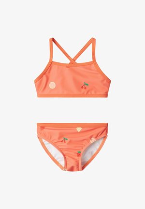 Two-piece swimsuit in bright orange fabric. Top has a cross-back design with fruit patterns; bottom features matching fruit decorative accents.
