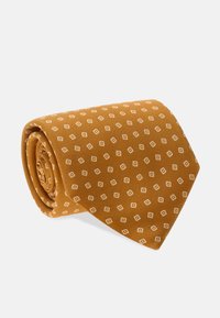 Hnědá kravata s texturovaným povrchem, zdobená vzorem malých bílých diamantů, upravená do úhledného tvaru pro prezentaci.