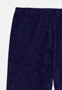 Navy blue towel pants made of plush terrycloth, featuring an elastic waistband and soft texture. No visible patterns or hardware.