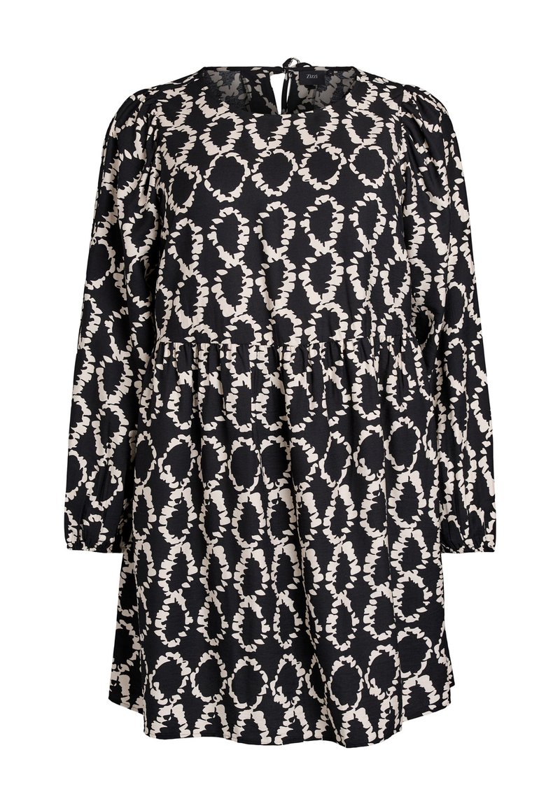 Vestido negro con mangas largas, cuello redondo y cierre en la parte posterior. Presenta un patrón ovalado abstracto en blanco y un diseño de falda en capas. Tejido suave.