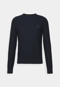 Granatowy sweter wykonany z teksturowanej dzianiny, z okrągłym dekoltem, długimi rękawami i małą naszywką z logo na piersi.